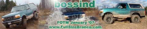 1996 Ford Bronco - Teal 1996 Ford Bronco navigating rough terrain with mud and water splashes.