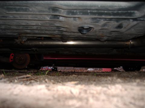 1998 Ford Taurus - Underside view of a car's exhaust system and brake components.