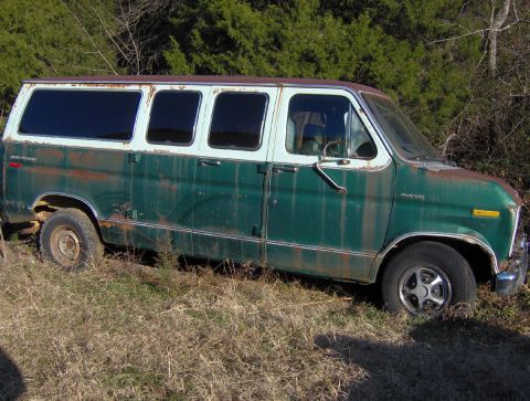 1978 Ford Bronco - This 1978 Ford Econoline van is parked in a grassy area with trees in the background.