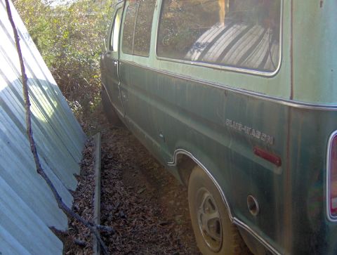 1978 Ford Bronco - The side of a green van is visible, with the words "CLUB-WAGON" on the body.