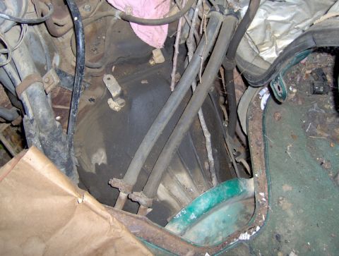 1978 Ford Bronco - Close-up view of an engine bay, showing hoses, wiring, and accumulated debris.