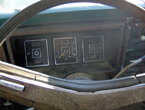 1978 Ford Bronco - The interior of an older vehicle shows the dashboard with fuel, temperature, and speedometer gauges.