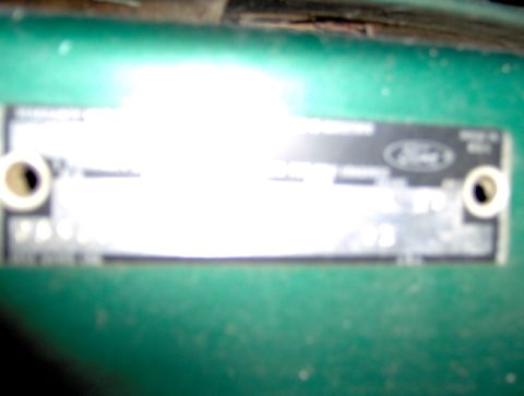 1978 Ford Bronco - Ford VIN plate detail on a green painted surface.