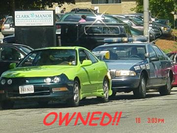 1997 Ford Crown Victoria - A police car is parked behind a green car, with other vehicles and a sign in the background.