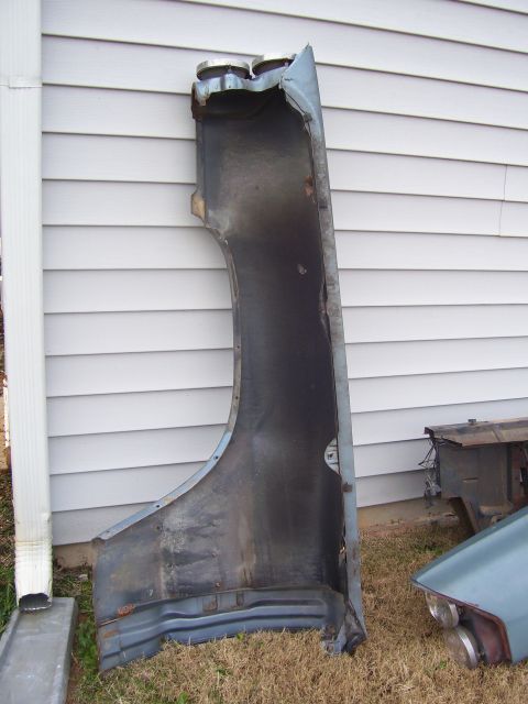 1965 Pontiac Catalina - A detached fender section is shown leaning against a house.