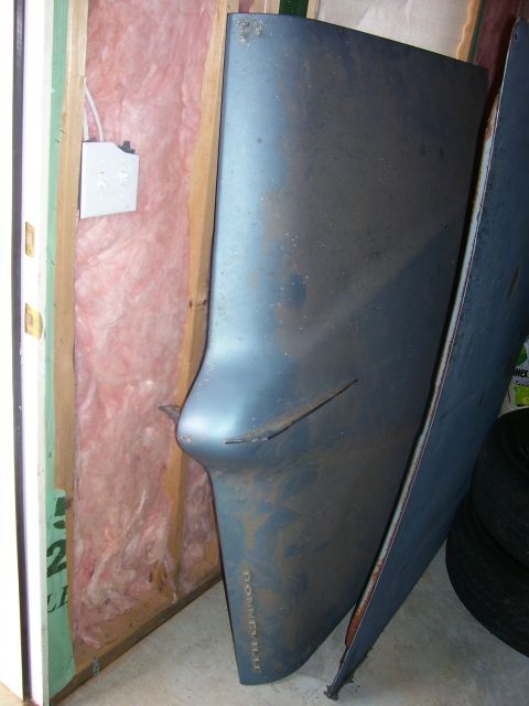 1965 Pontiac Catalina - A car fender with 'BONNEVILLE' text is stored indoors, leaning against an unfinished wall.