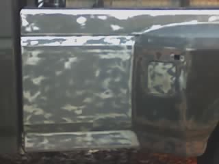 1990 Ford F-350 - Close-up of a truck bed undergoing repairs, revealing extensive bodywork.