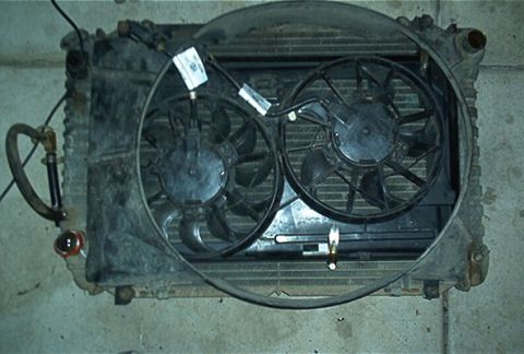 1986 Ford Bronco - Radiator assembly with dual electric fans, hoses, and wiring visible. Part of an electric fan install.