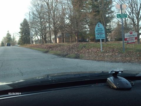1995 Ford Probe - Roadside view with signs for United Methodist Church and Carpenter real estate.