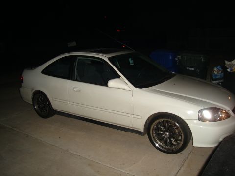 1997 Ford Probe - This white coupe is parked outside at night, showing its aftermarket wheels.