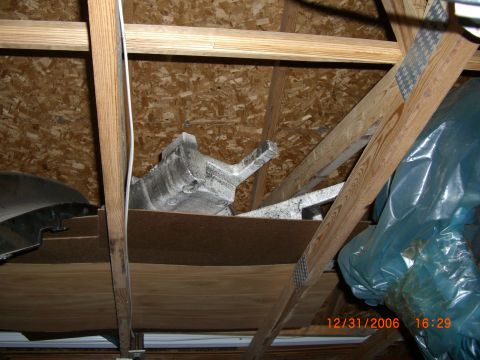 1993 Ford Probe - An aluminum automotive part is stored in an attic, surrounded by wooden beams and insulation.