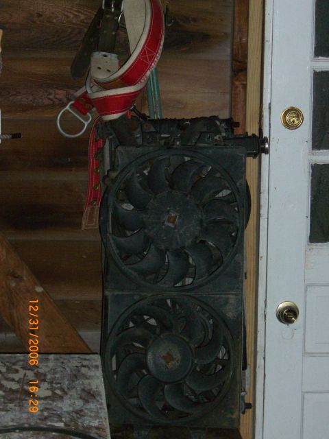 1993 Ford Probe - Radiator and fan assembly, likely for a vehicle, is shown mounted indoors.