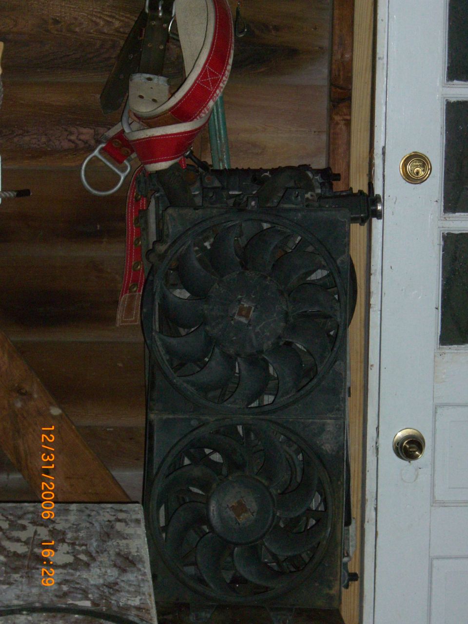 Radiator and dual fan assembly, black, mounted vertically indoors