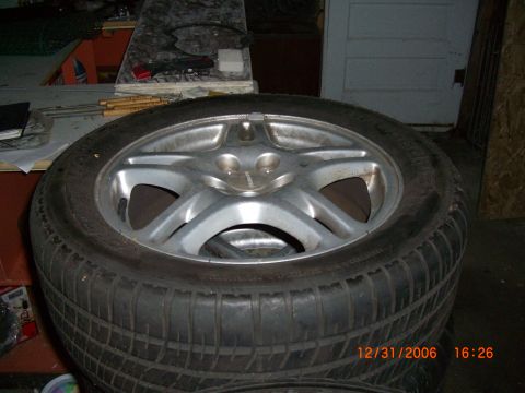 1993 Ford Probe - Close-up of a tire and wheel assembly, likely for sale.