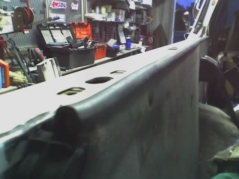 1993 Ford C-350 (Centurion Conversions) - Close-up view of a truck bed rail, showing its construction and rubber trim detail.