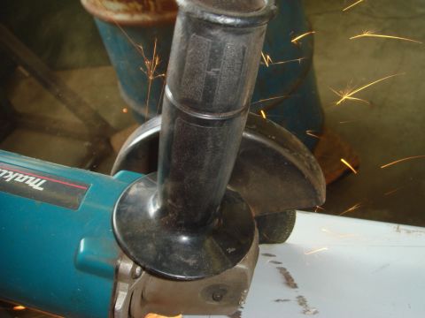 1996 Ford Bronco - An angle grinder is used to cut a piece of metal, creating a shower of sparks.