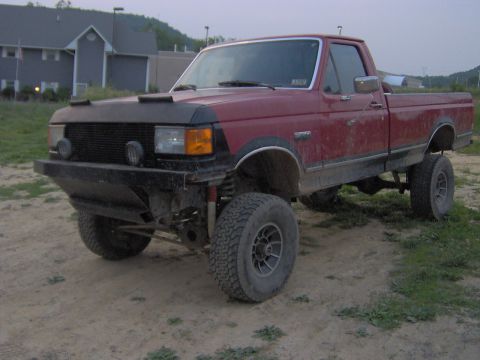 1990 Ford F-150 - This 1990 Ford F-150 pickup truck features a custom bumper and suspension lift.