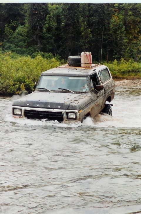 1978 Ford Bronco - This 1978 Ford Bronco navigates a river crossing, equipped with a spare tire and fuel can on its roof.