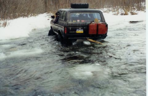 1978 Ford Bronco - 1978 Ford Bronco navigates a frozen waterway, equipped with extra fuel and a spare tire.
