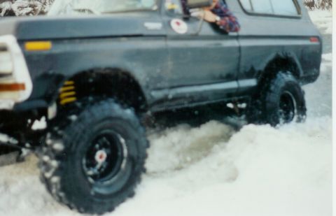 1978 Ford Bronco - This 1978 Ford Bronco is shown navigating through a snowy terrain, kicking up snow as it moves.