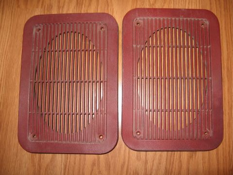 1994 Ford Bronco - A pair of maroon speaker grilles, likely interior trim pieces, are shown against a wooden background.
