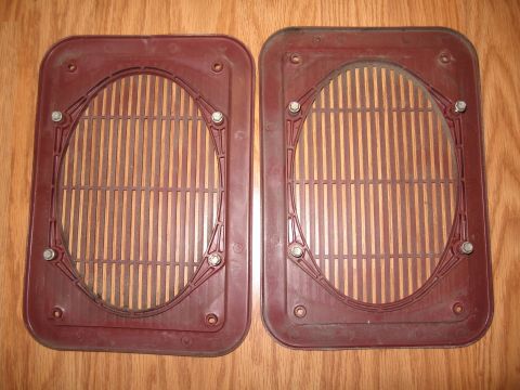 1994 Ford Bronco - Pair of maroon plastic speaker grilles with vertical slats, held by bolts.