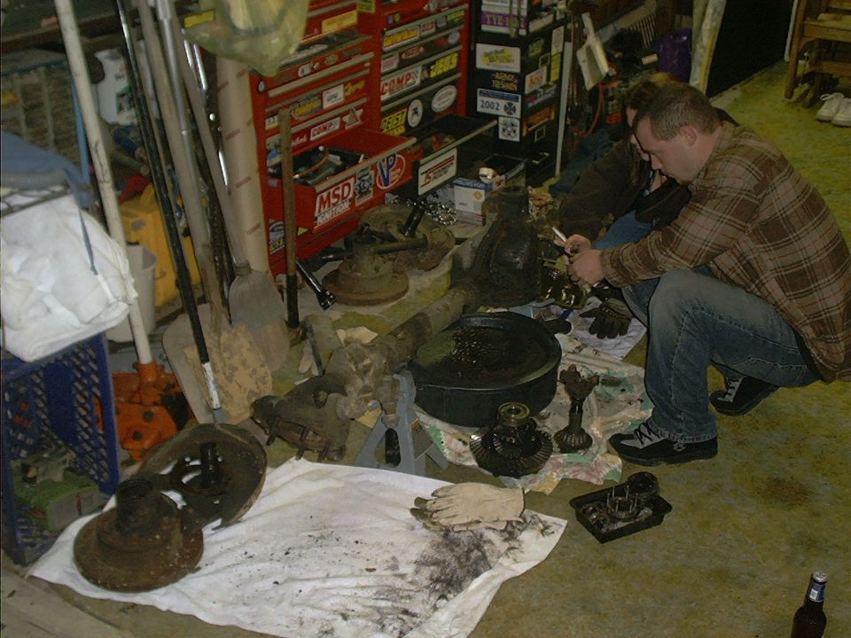Mechanic disassembling differential gears on a workbench
