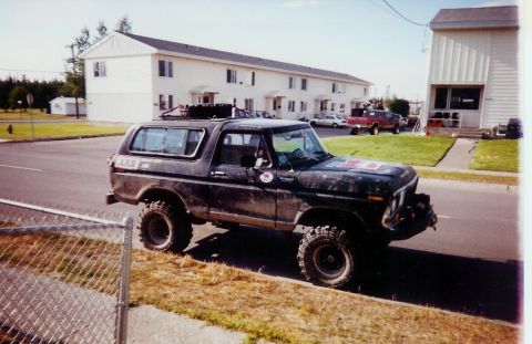 1978 Ford Bronco - A modified 1978 Ford Bronco sits parked on the side of a street, with apartment buildings in the background.