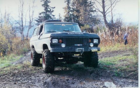 1978 Ford Bronco - Modified 1978 Ford Bronco navigating a challenging off-road course with large tires and a winch.