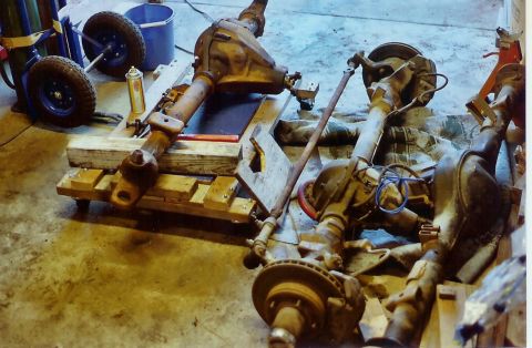 1978 Ford Bronco - Various vehicle axle assemblies and related parts are shown disassembled in a workshop setting.