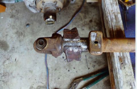 1978 Ford Bronco - Close-up of a welded axle component, with a hub assembly visible in the background.