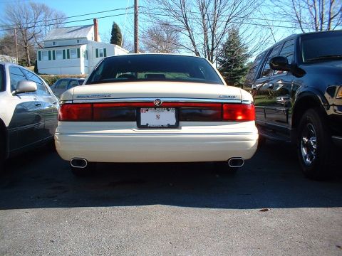 1996 Mercury Grand Marquis - Rear view of a 1995 Mercury Grand Marquis and a black SUV parked side-by-side.