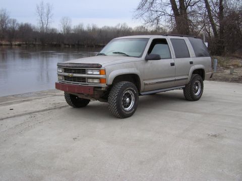 2000 Chevrolet Tahoe - This Chevrolet Tahoe features an aftermarket front bumper and is parked near a river.