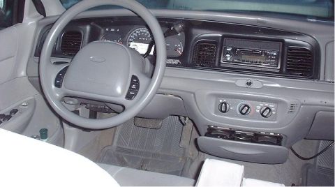 1997 Ford Crown Victoria - The interior of a 1997 Ford Crown Victoria displays its dashboard, steering wheel, and center console.