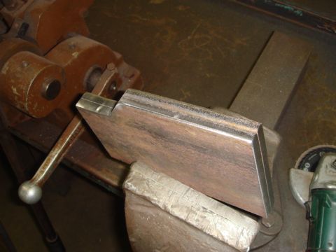 1996 Ford Bronco - Metal part secured in a vise, ready for fabrication or repair.