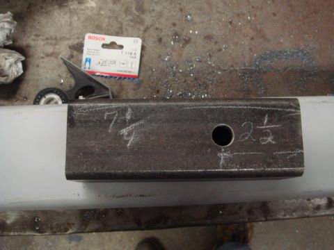 1996 Ford Bronco - A metal bracket with measurements marked in chalk is shown, alongside a package of Bosch saw blades.