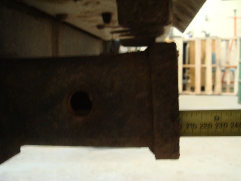 1996 Ford Bronco - A close-up of a rusty hitch receiver is shown with a measuring tape indicating its dimensions.