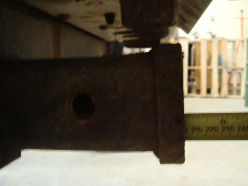 Rusted metal hitch receiver with a measuring tape showing 210-240 units