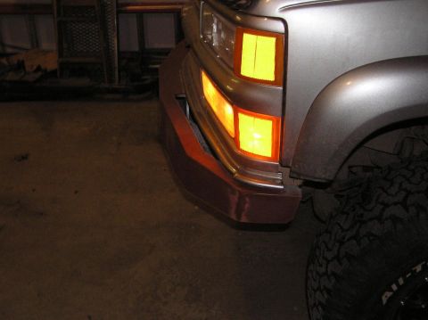 2000 Chevrolet Tahoe - Close-up of the front bumper and amber turn signal on a 1995 Chevrolet K1500.