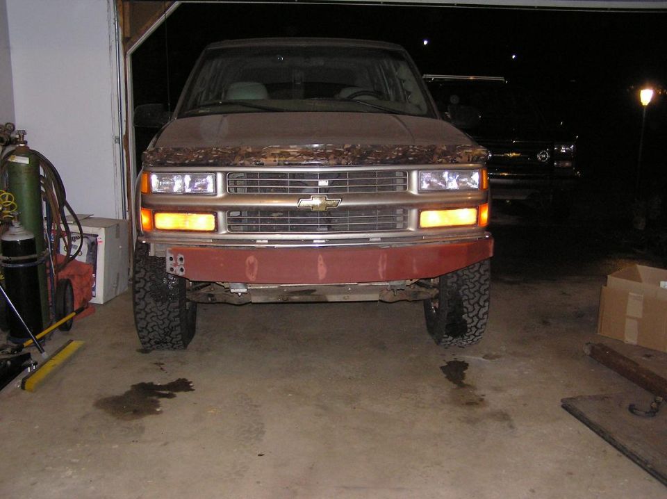 Front bumper of a 1995 Chevrolet Tahoe with a red primer finish