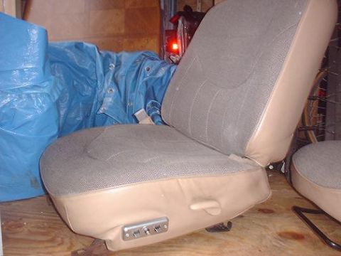 1997 Ford Crown Victoria - A tan and grey fabric car seat with visible power controls is shown, likely from an older model vehicle.