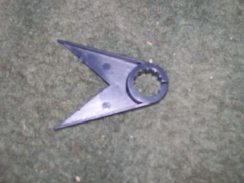 1992 Ford Bronco - A close-up view of a black plastic automotive component resting on a carpeted surface.
