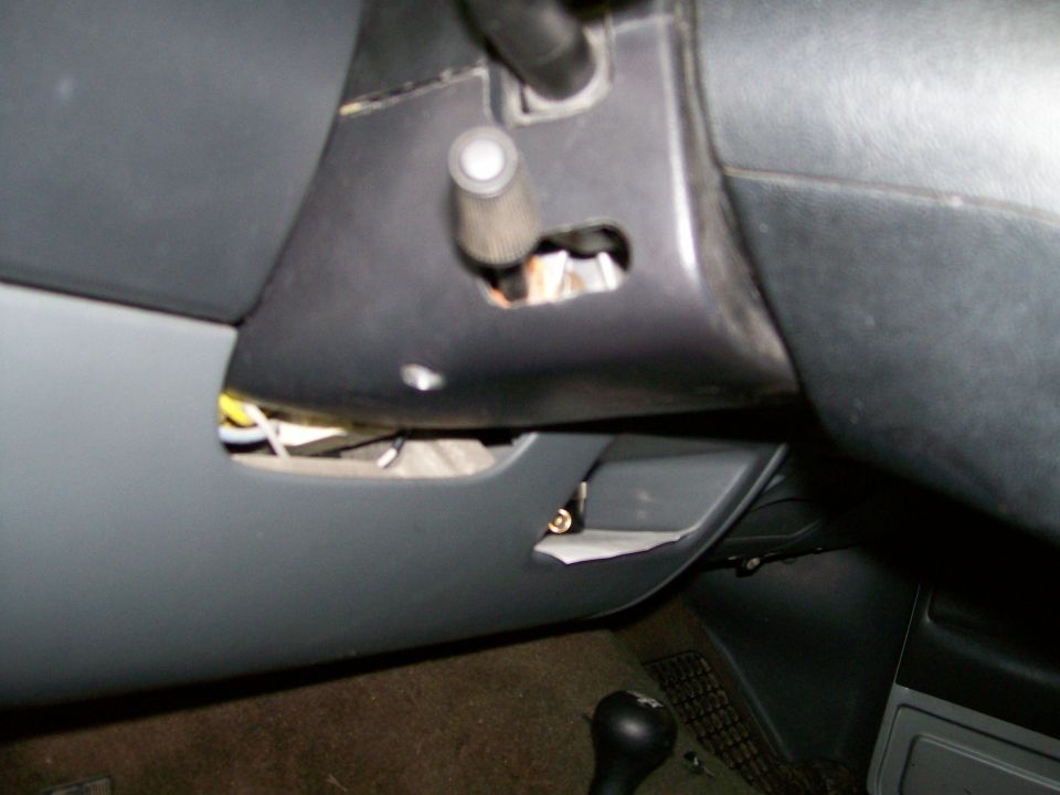 Under-dash steering column area with trim removed, wiring and switch shaft exposed