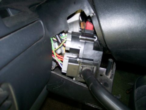 1992 Ford Bronco - Close-up view of the steering column's electrical components, showing a complex wiring harness and ignition switch mechanism.