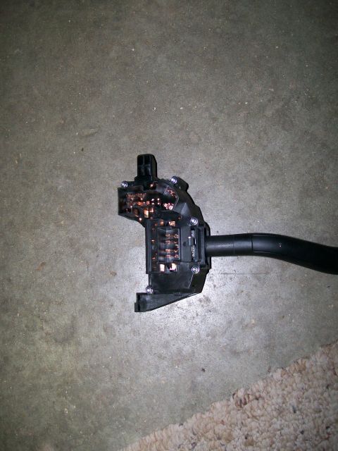 1992 Ford Bronco - Turn signal switch assembly shown on a concrete floor.