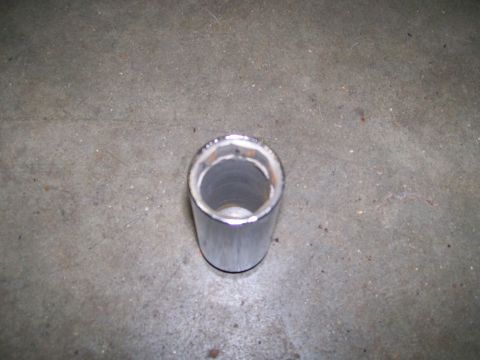 1992 Ford Bronco - A chrome exhaust pipe is shown from a top-down perspective on a concrete surface.