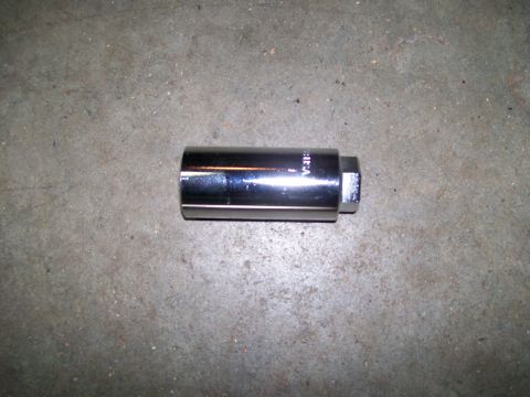 1992 Ford Bronco - A chrome spark plug socket, marked 'USA', rests on a concrete surface.