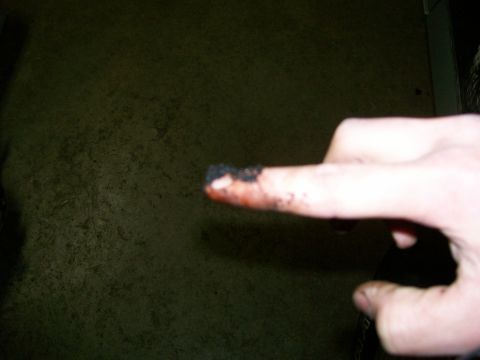1992 Ford Bronco - A finger shows grease and dirt, likely from working on a vehicle.
