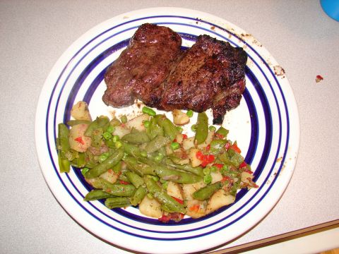 1996 Ford Bronco - A plate of food with two steaks and a vegetable medley is shown, with a watermark at the bottom right.