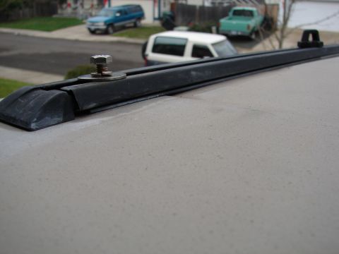 1996 Ford Bronco - Detail of a roof rack attachment on a vehicle's roof, with other cars visible in the distance.
